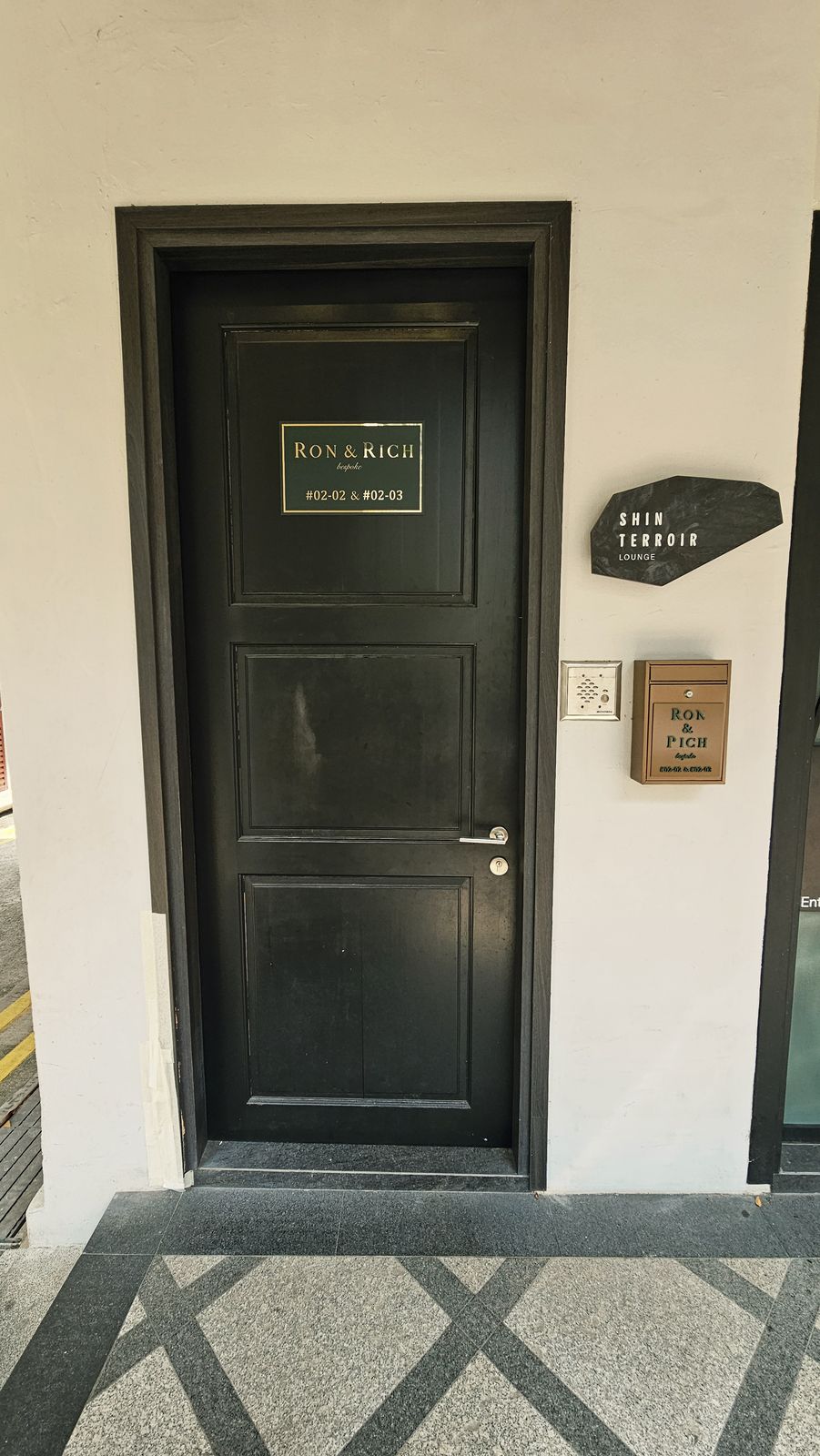 The entrance to Ron & Rich, #02-02 & #02-03