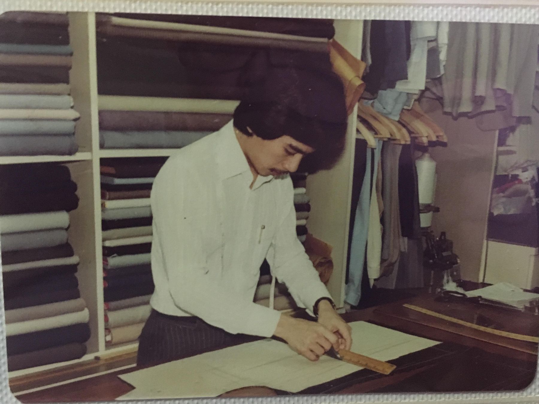 A young Richard Fan drafting a pattern at the cutting table, 1979
